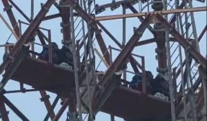 Gonda Woman Climb on Tower With Child (CREDIT-SM)